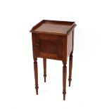 A Victorian mahogany tray top bedside cupboard, enclosed by a single panelled door raised on