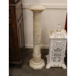 A decorative alabaster jardinière stand, having turned and fluted column on octagonal base, 103cm