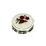 A silver and enamel compact, brightly decorated with sprigs of red roses, 7.5cm dia.