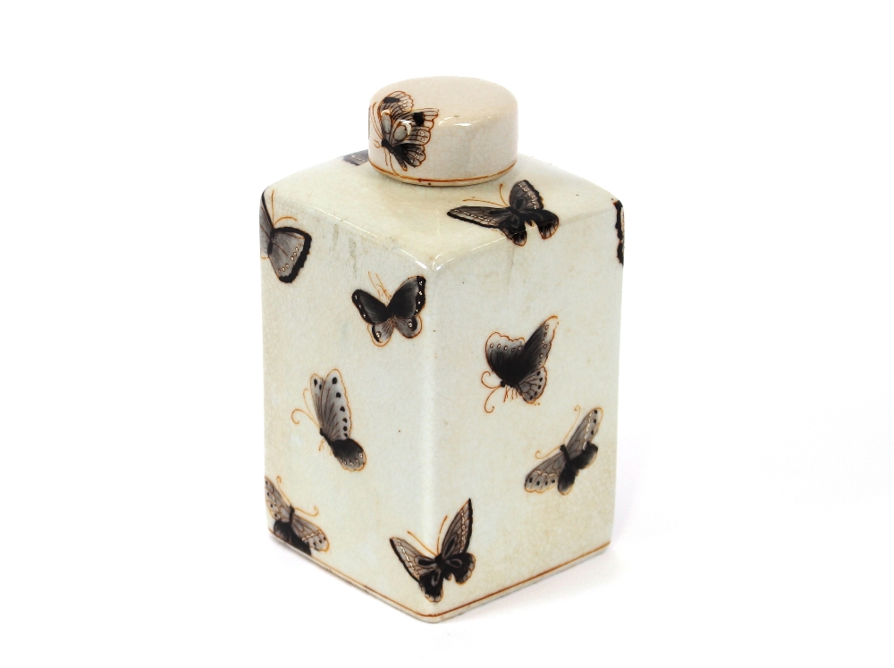 A Chinese crackle glaze tea canister and cover, painted with flowers, butterflies and moths, 16cm