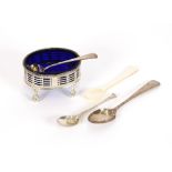 An oval George III silver pierced salt, with blue glass liner raised on ball and claw feet; a