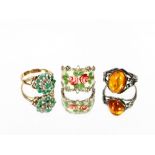 A 9 carat gold two stone emerald and diamond ring; a silver and enamel ring and a silver and amber
