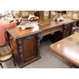 A large Victorian carved mahogany breakfront pedestal sideboard, fitted central drawer flanked by