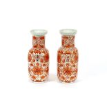 A pair of 19th Century Chinese porcelain Rouleau vases, painted with overall iron red decoration