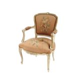 A 19th Century French style cream and gilt decorated elbow chair, having needlepoint upholstered