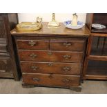 A Georgian mahogany and elm chest, fitted two short and three long drawers, raised on bracket