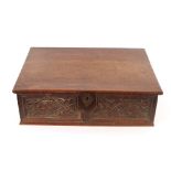 An 18th Century carved oak bible box, having leaf decorated frieze, 59cm wide