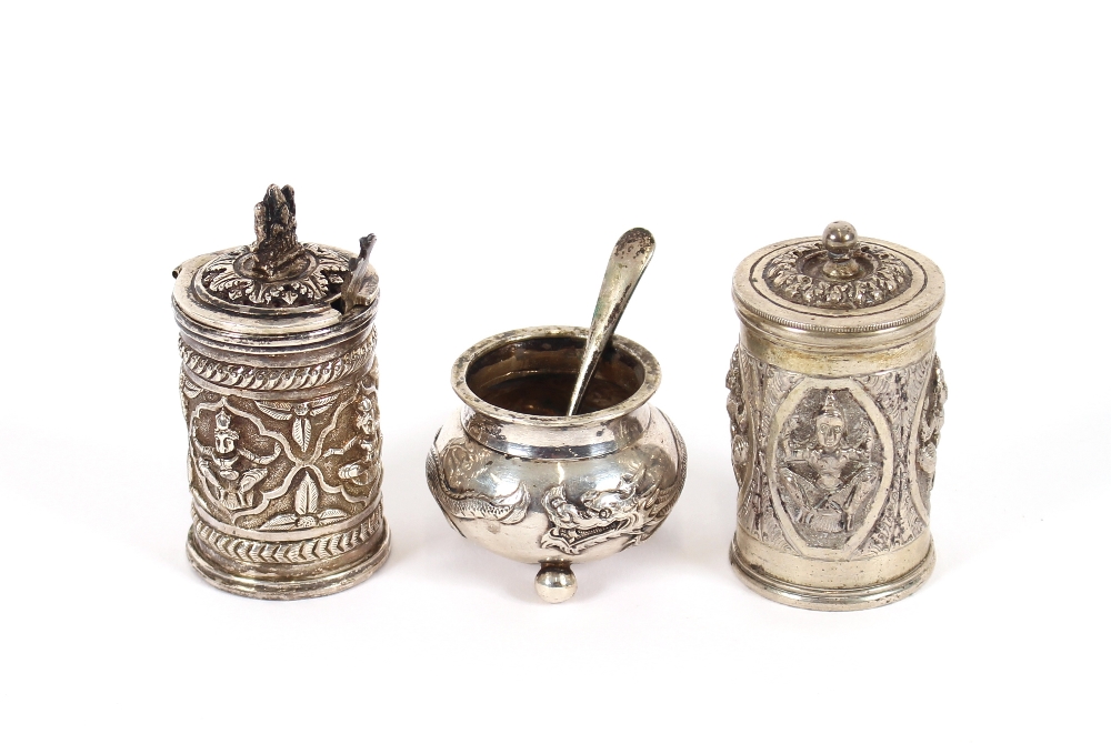 An Eastern white metal pepper pot and mustard, 7cm high; and a Chinese white metal cauldron shaped