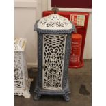 A Victorian cast iron and enamel heater, having foliate pierced decoration raised on scroll feet,