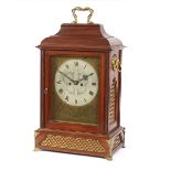 A large 19th Century mahogany cased mantel clock, surmounted by a coiled serpent handle, the brass