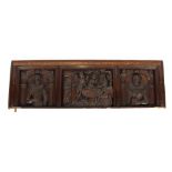 A carved oak Jacobean overmantel, the three sections decorated with various scenes including a man