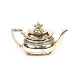 A George III silver teapot, with fluted decoration, raised on ball feet, London 1813, 29cm long x