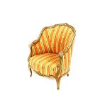 A 19th Century French cream and gilt decorated salon easy chair, the shaped back with foliate