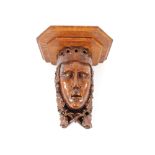 An Antique carved fruitwood wall bracket, in the form of a monarch's head, 34cm