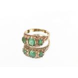 A 9 carat gold three stone emerald and diamond ring