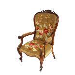 A Victorian rosewood spoon back armchair, the cresting rail with pierced foliate decoration,