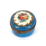 A late 19th Century Paris porcelain circular box, decorated with flowerheads on a blue ground, 5cm