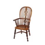 A 19th Century yew wood and elm Windsor chair, with arched stick back and central pierced splat,