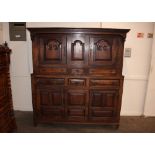 An Antique oak court cupboard, the upper section surmounted by a canopy above fielded panelled doors
