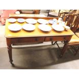 A Victorian mahogany two drawer writing table, raised on tapering reeded supports terminating in