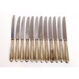 A set of twelve silver handled steel bladed dinner knives