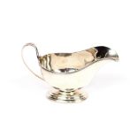 A modern silver sauce boat, having reeded border decoration on oval spread foot, Sheffield 1967