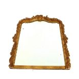 19th Century gilt framed wall mirror, profusely decorated with foliate scrolls, 133cm x 89cm in