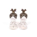 A pair of late Victorian glass and silver mounted scent bottles, of waisted form with foliate