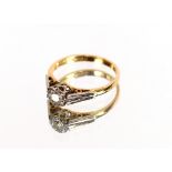 An 18 carat gold and diamond set ring