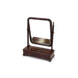 A late Victorian mahogany swing frame toilet mirror, the bevel plate raised on tapering reeded