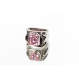 A large silver and pink stone set dress ring