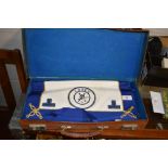 A Masonic apron in brown leather case