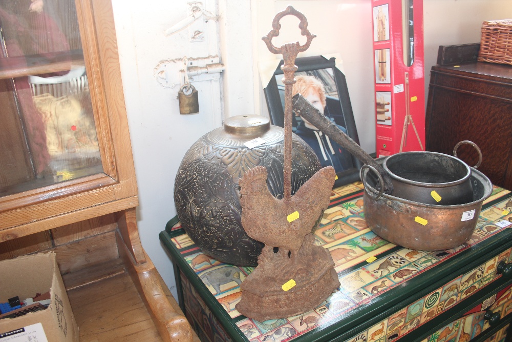 A brass light shade together with a cast iron door