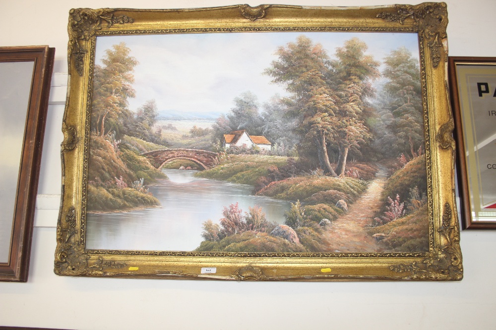 A gilt framed oil on canvas depicting a river scen