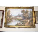 A gilt framed oil on canvas depicting a river scen