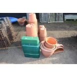 A large quantity of plastic plant pots