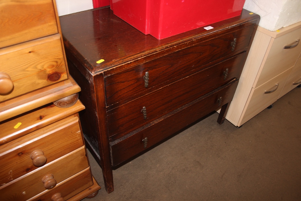 An oak chest fitted three long drawers