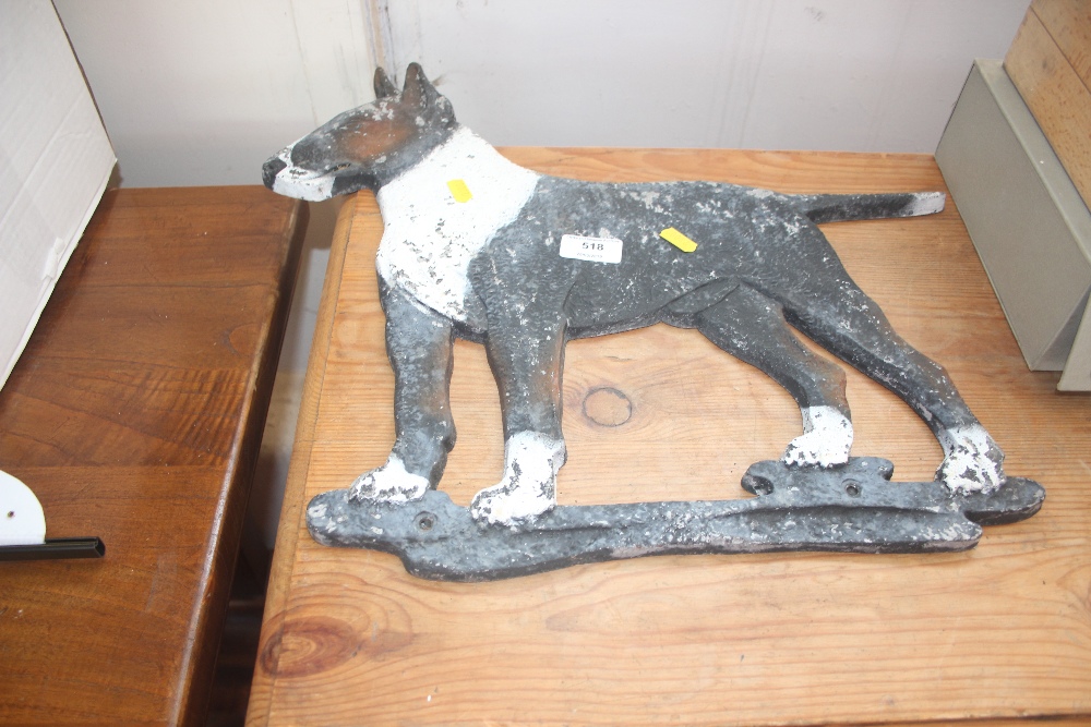 A cast metal wall plaque in the form of a dog