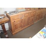 A pine sideboard fitted three drawers