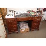 A mahogany leather top writing desk