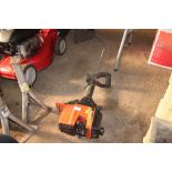 A petrol Flymo strimmer