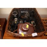 A basket and contents of various cameras and lense