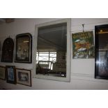 A framed bevel edged wall mirror