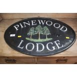 A metal sign "Pinewood Lodge"