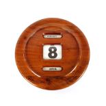 A circular mahogany cased wall calendar