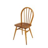 A set of four light Ercol stick back kitchen chairs