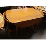 A teak G plan design drop leaf dining table; and four matching chairs