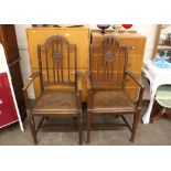 A pair of oak elbow chairs, by James Schoolbred &