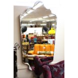 A large modern design decorative bevel edged shaped wall mirror