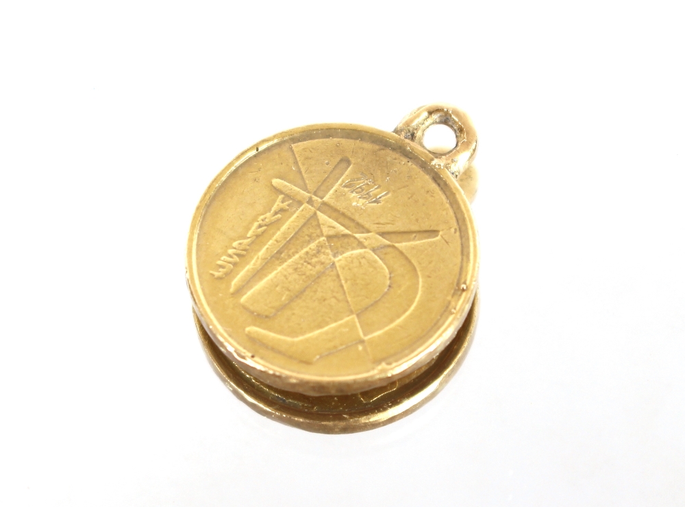 A five peseta gold coin, converted to a pendant; a